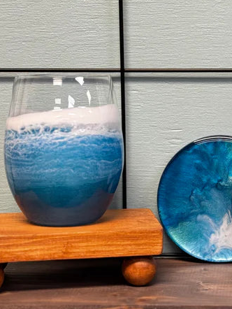 Set of blue and white ceramic items on a wooden surface with a tiled wall background